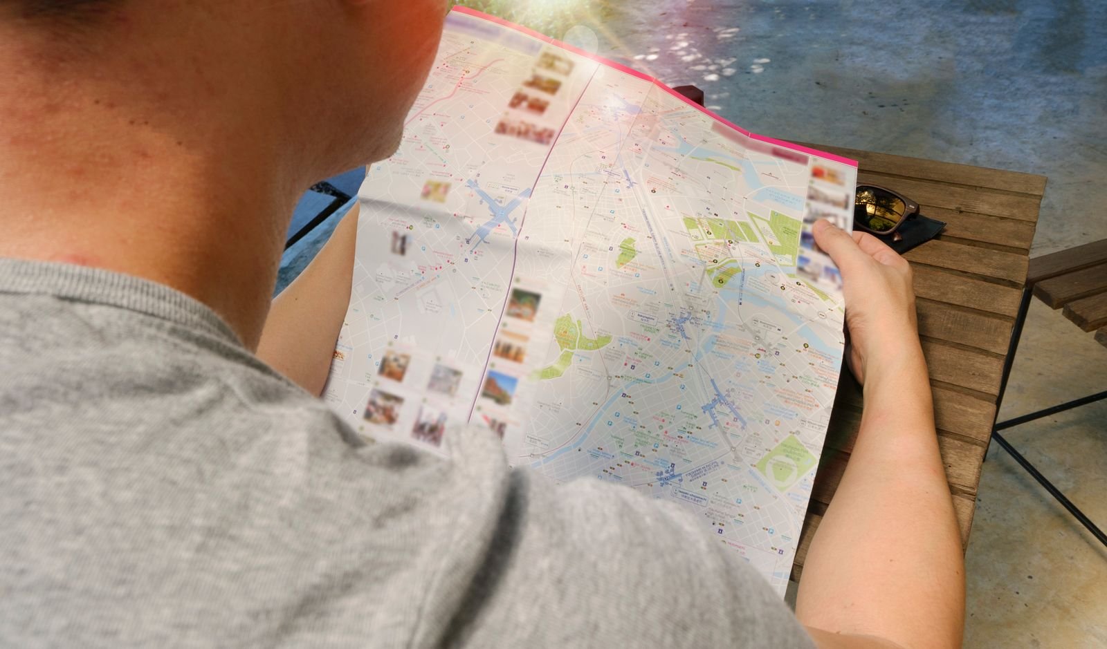 A traveler examining a paper map while planning a multilingual trip